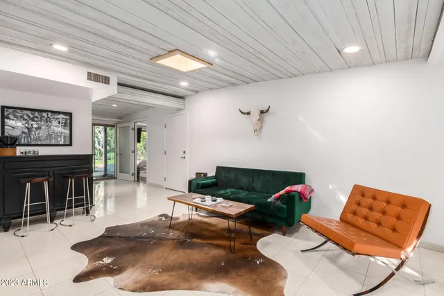 a living room with furniture chess board and a rug