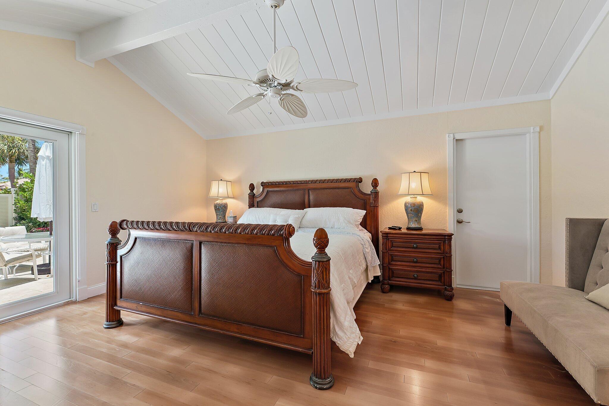 107 Mako Lane Jupiter, FL 33477 - Photo 15 of 41 a bedroom with a bed and wooden floor
