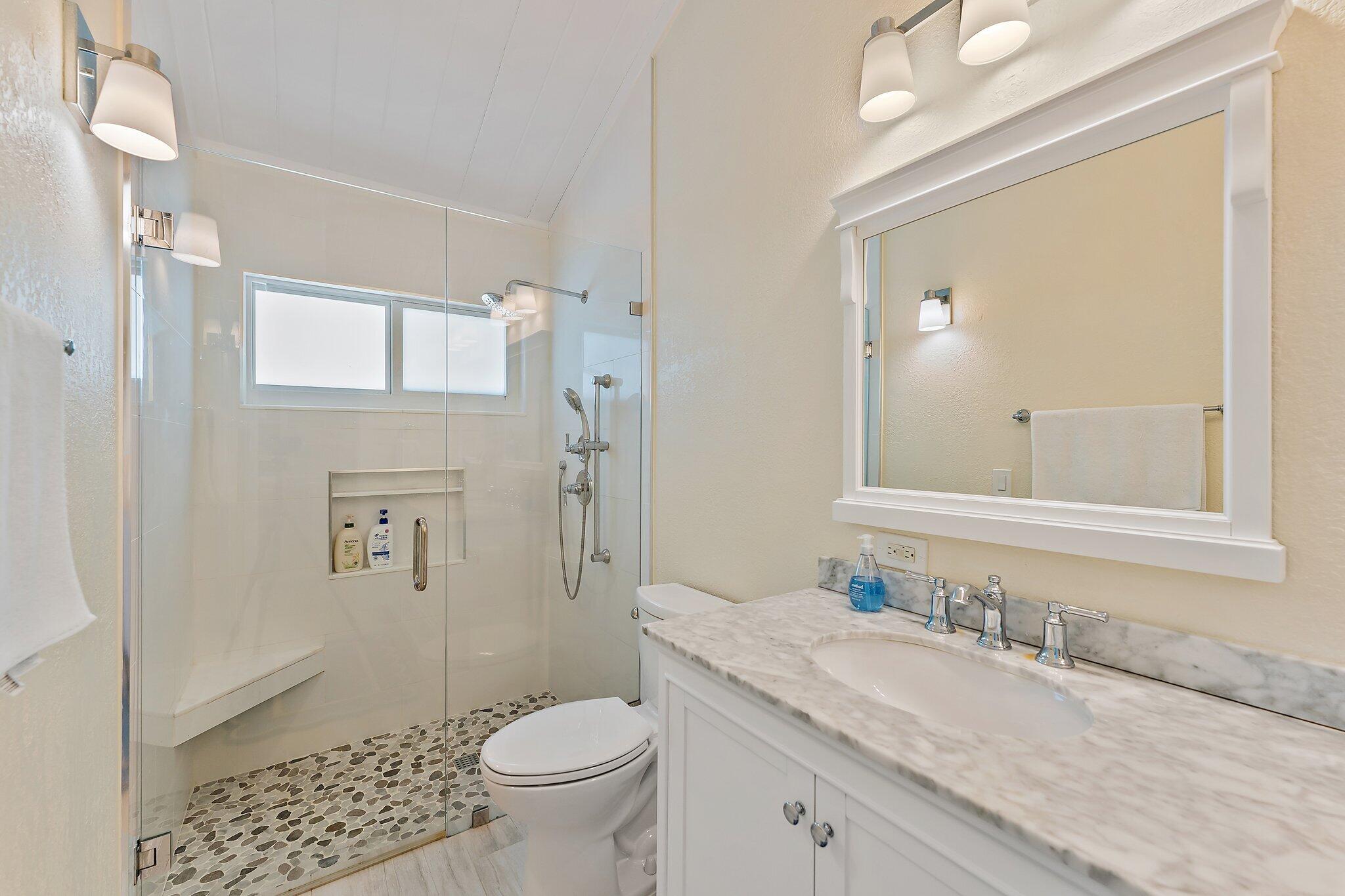 107 Mako Lane Jupiter, FL 33477 - Photo 18 of 41 a bathroom with a granite countertop sink toilet and shower