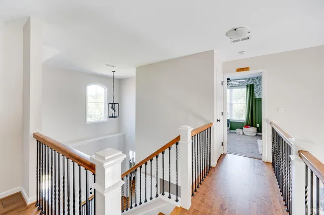 a kitchen with a stove a sink and a wooden floor