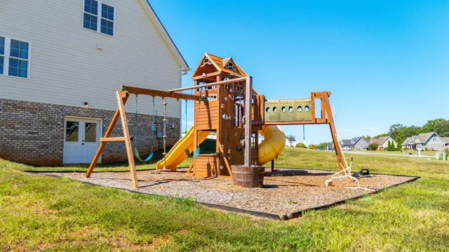 a view of a house with backyard and sitting area
