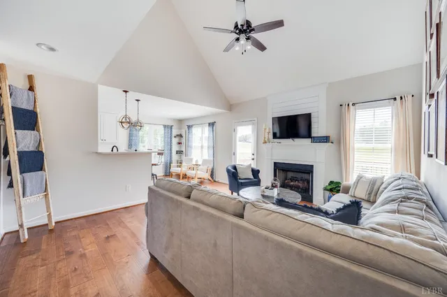 a living room with furniture a fireplace and a large window