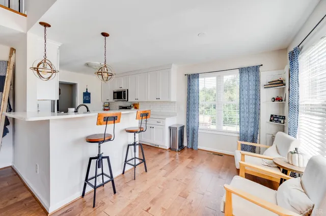 a kitchen with stainless steel appliances a stove sink microwave and cabinets