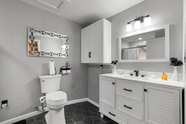 a bathroom with a toilet sink and mirror