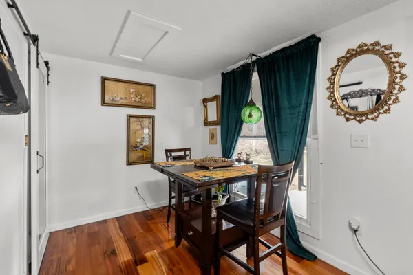 a view of a dining room with furniture and window