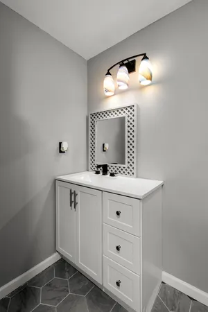 a bathroom with a sink a vanity and a mirror