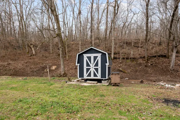 a backyard of a house with a table and chair