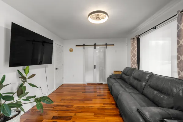 a living room with furniture and a flat screen tv