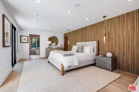 a spacious bedroom with a bed and a large window