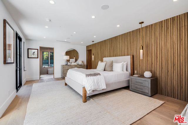 a spacious bedroom with a bed and a large window