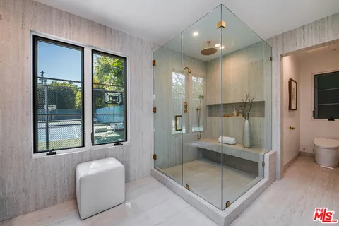 a bathroom with a glass shower door and a bathtub