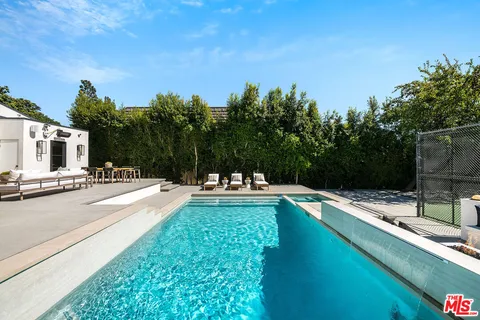 a view of a swimming pool with a lounge chairs
