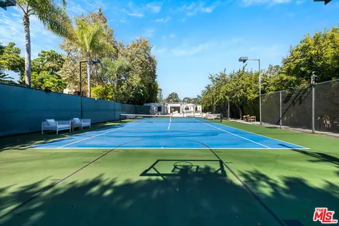 a view of an outdoor space and basketball court