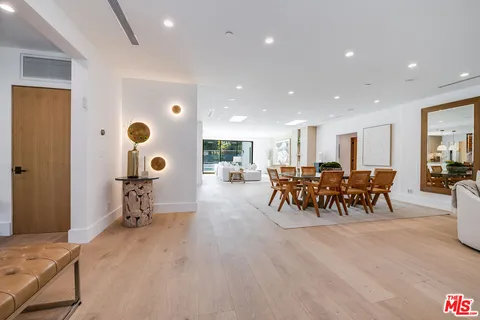 wooden floor and dining room with furniture and a table
