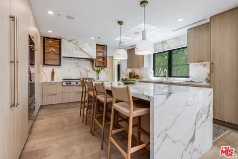 a large kitchen with a table and chairs