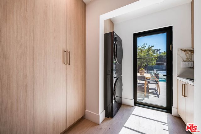 a view of a hallway with windows and door