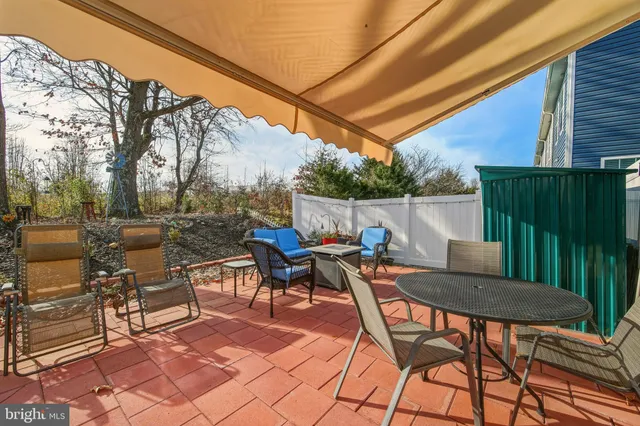 a backyard of a house with table and chairs