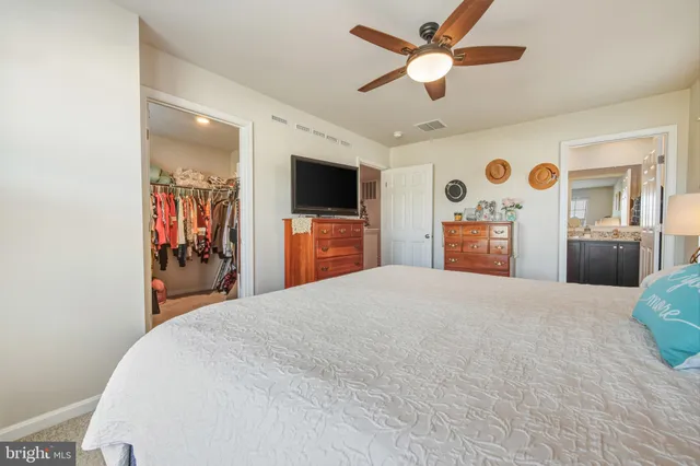 a bedroom with furniture and a flat screen tv