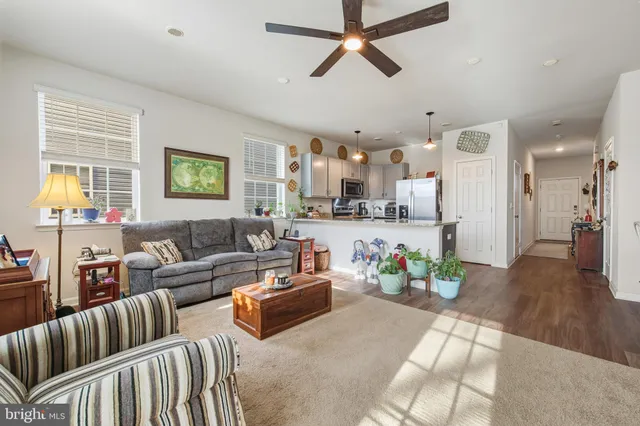 a living room with furniture kitchen and a window