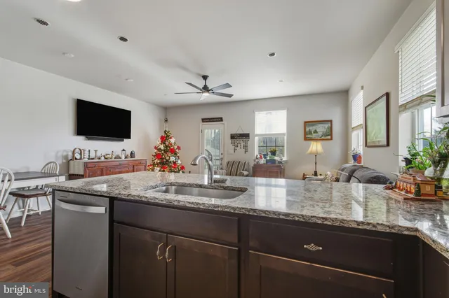 a kitchen with sink microwave and view living room