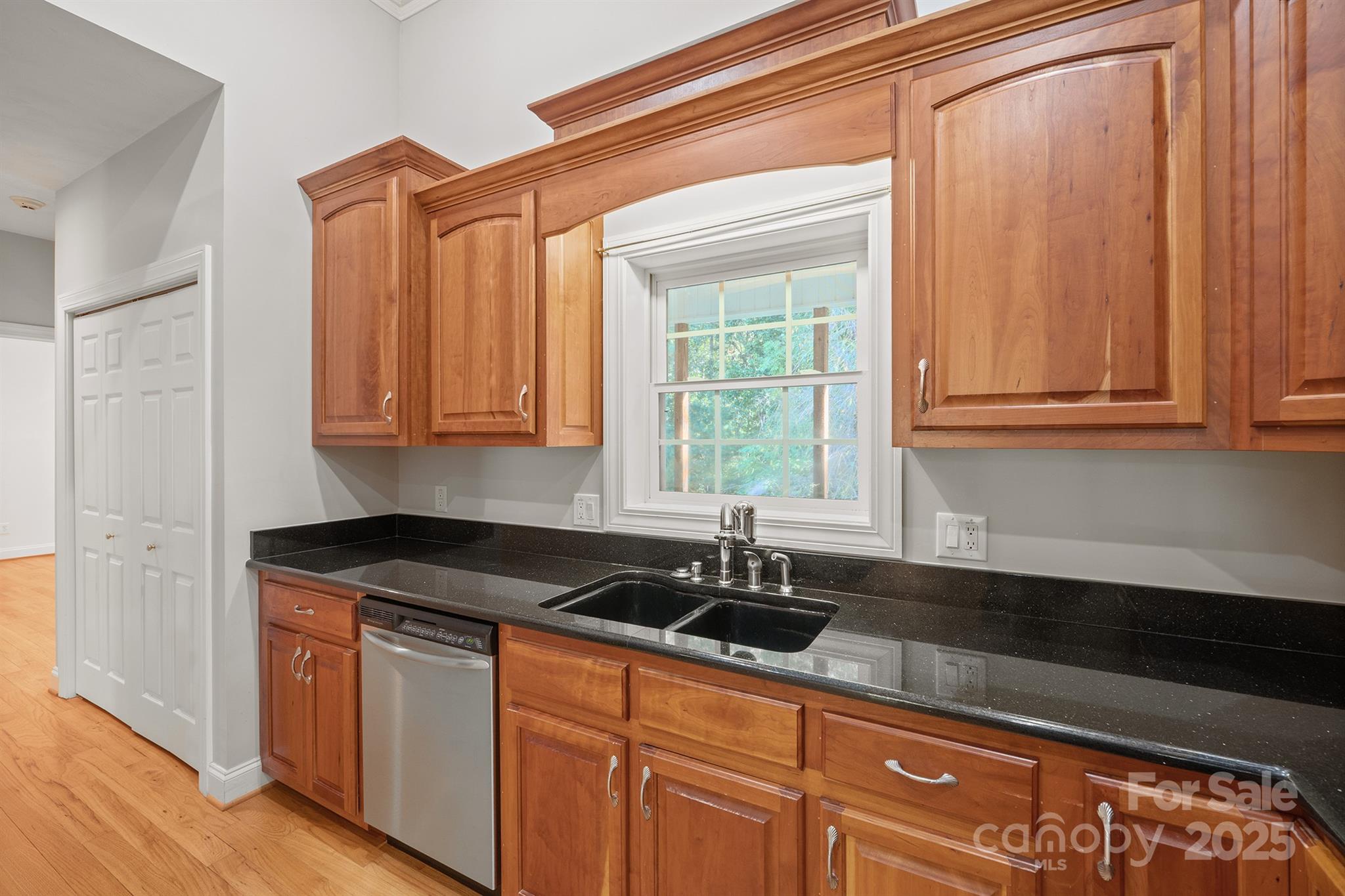 5350 Beacon Ridge Drive Granite Falls, NC 28630 - Photo 13 of 48 a kitchen with stainless steel appliances granite countertop a sink a stove and a granite counter tops with wooden floors