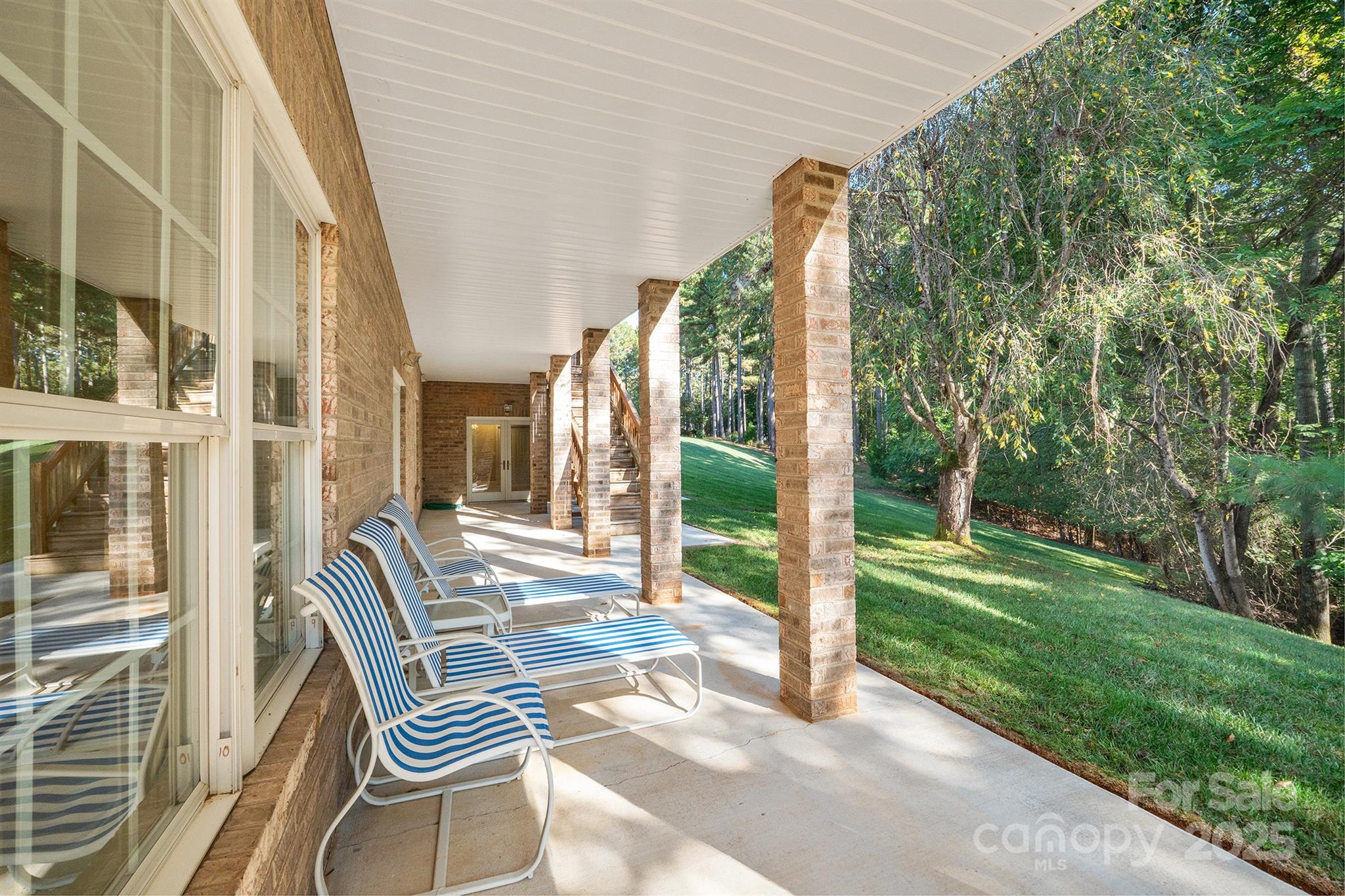 5350 Beacon Ridge Drive Granite Falls, NC 28630 - Photo 42 of 48 a view of balcony with two chairs and a large tree