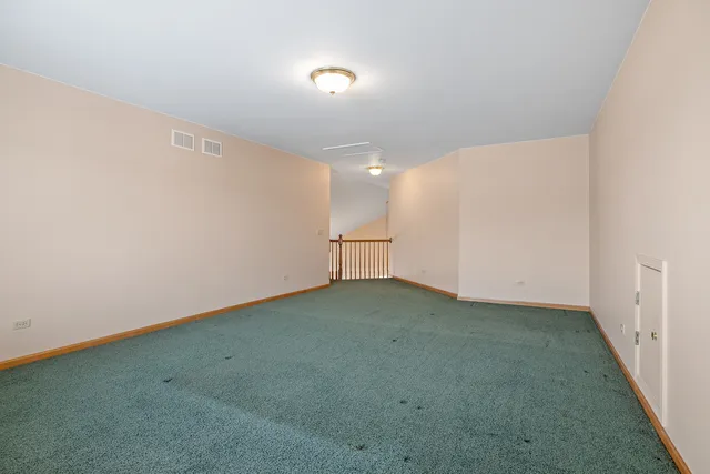 an empty room with closet and windows