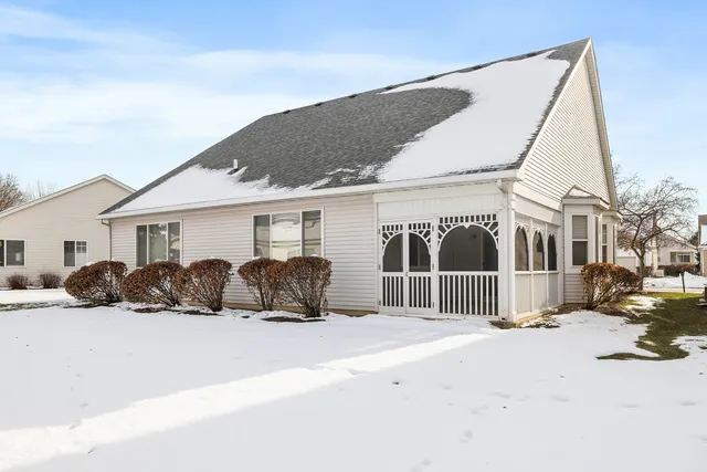 a view of a house with a yard covered in snow