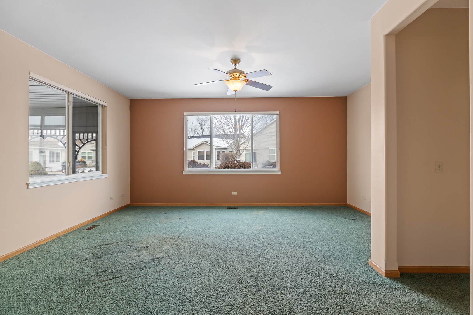 631 Saugatuk Circle Romeoville, IL 60446 - Photo 8 of 22 an empty room with windows and chandelier fan