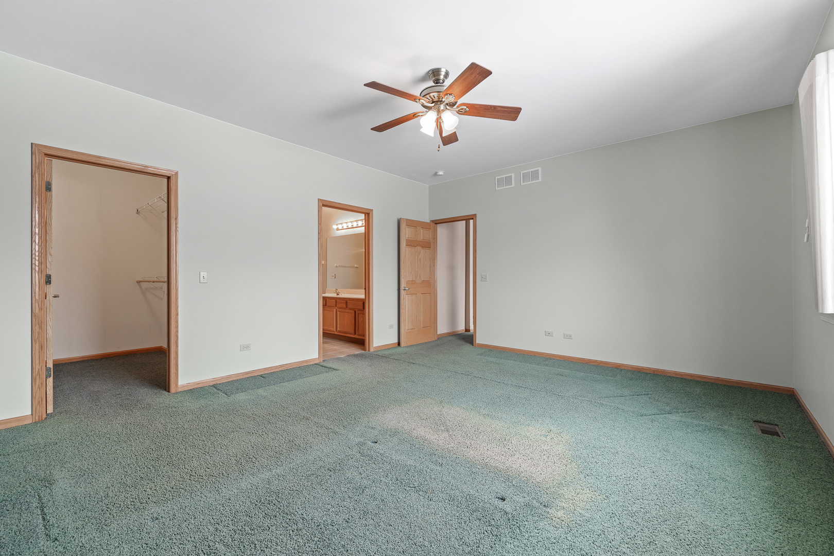 631 Saugatuk Circle Romeoville, IL 60446 - Photo 10 of 22 an empty room with ceiling fan and window