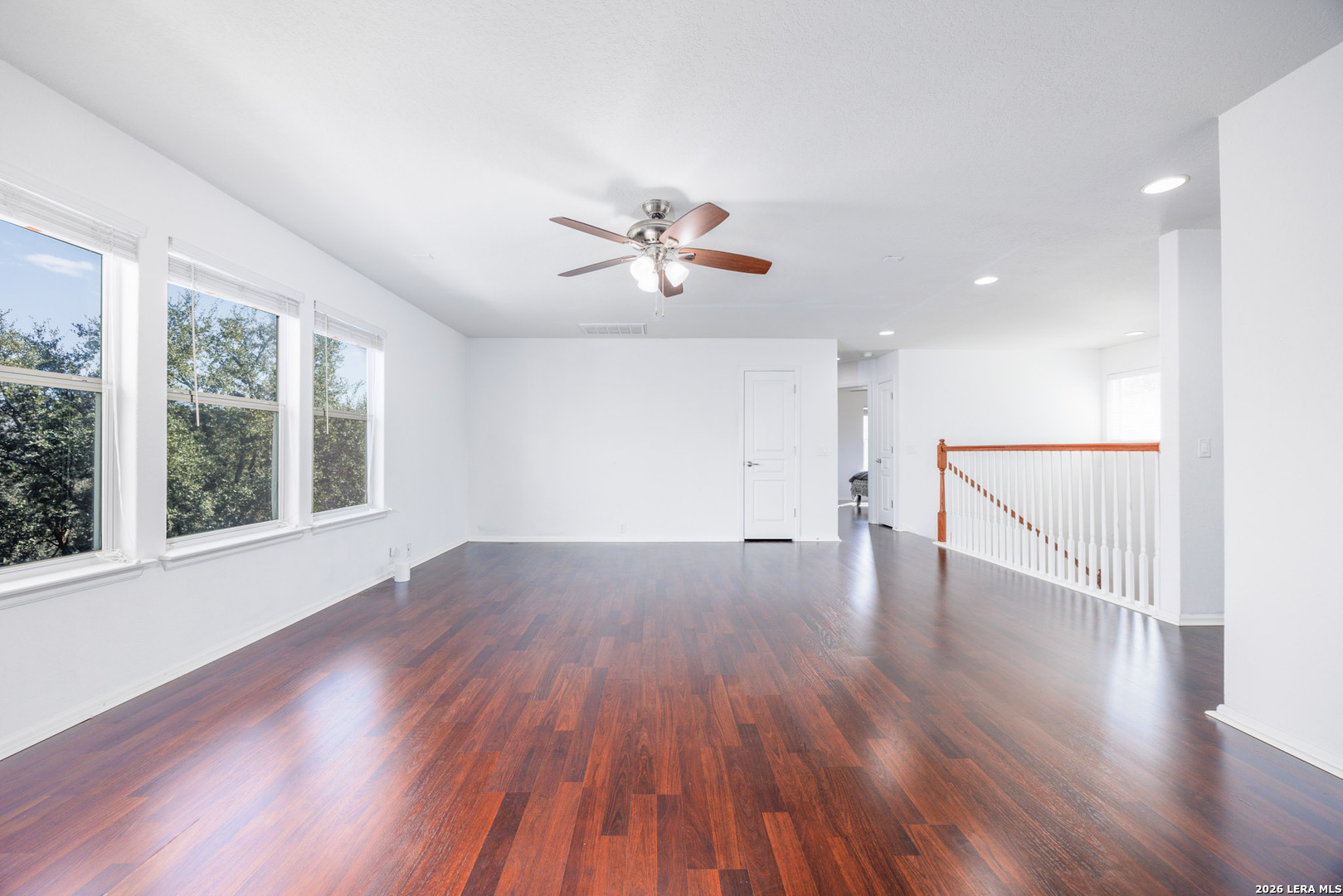 4702 Thomas Rusk San Antonio, TX 78253 - Photo 12 of 18 a view of an empty room with wooden floor and a ceiling fan