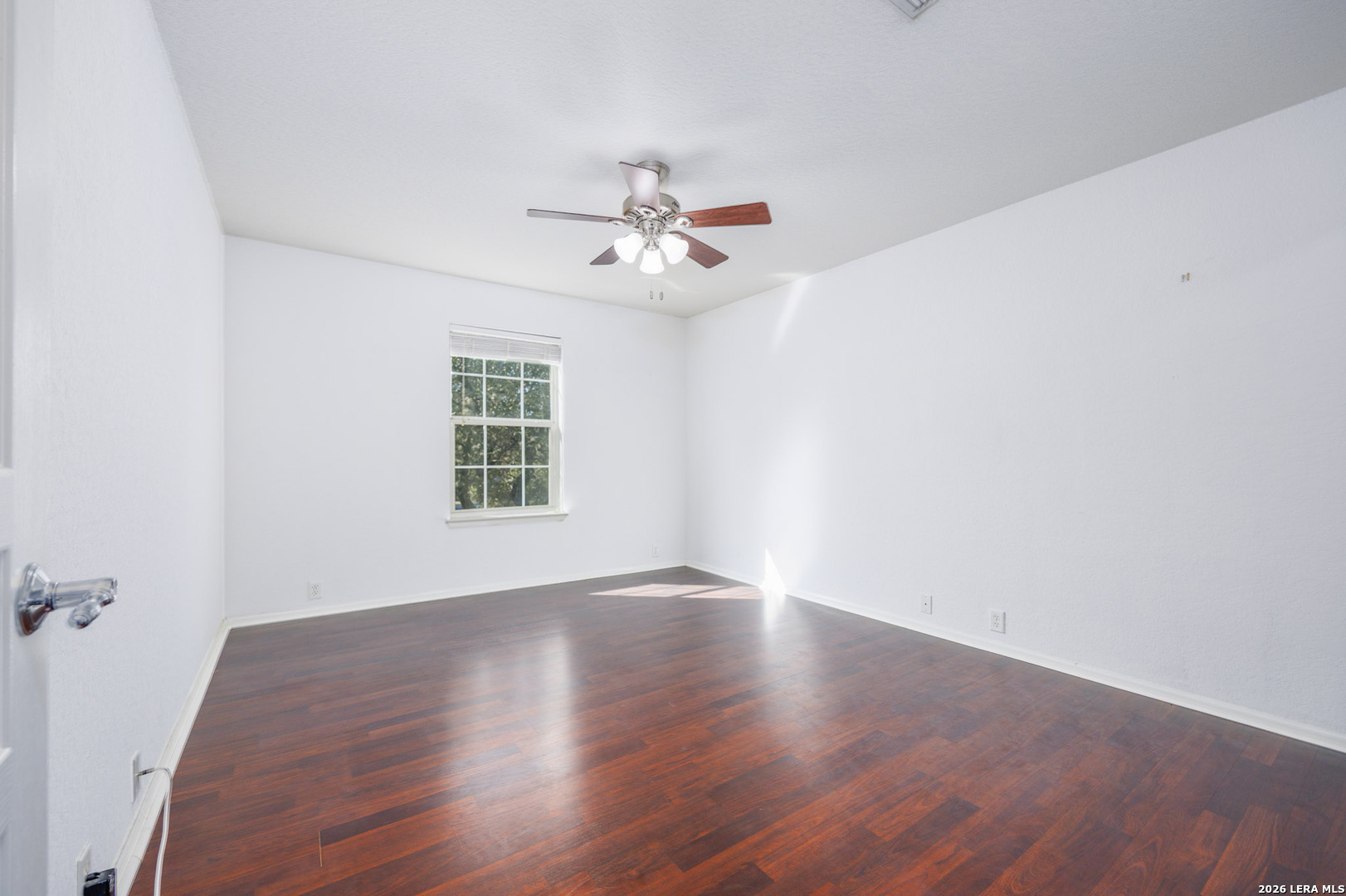 4702 Thomas Rusk San Antonio, TX 78253 - Photo 16 of 18 wooden floor in an empty room with a window
