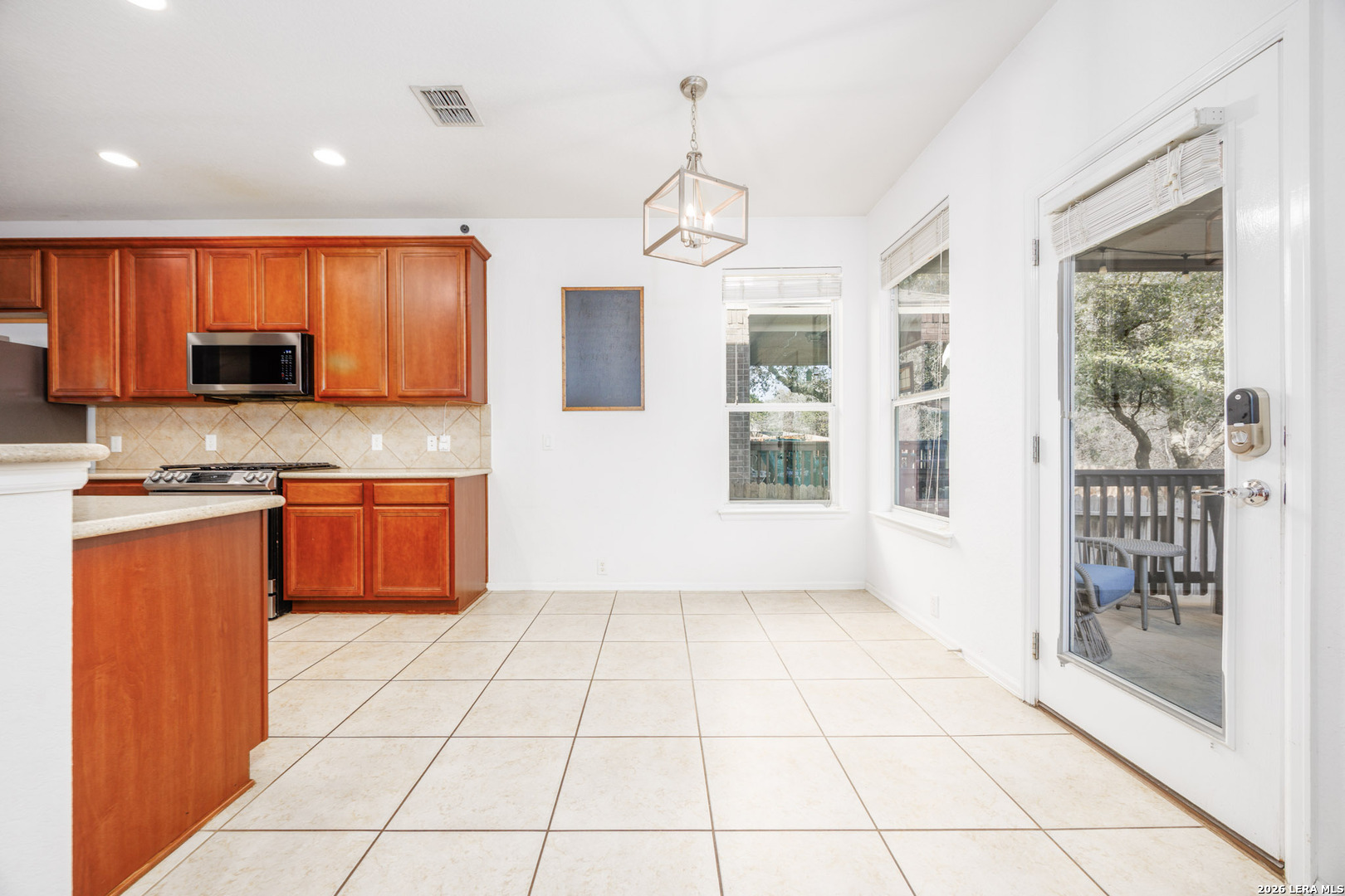 4702 Thomas Rusk San Antonio, TX 78253 - Photo 5 of 18 a kitchen with stainless steel appliances granite countertop a refrigerator a sink a stove top oven and a view of living room