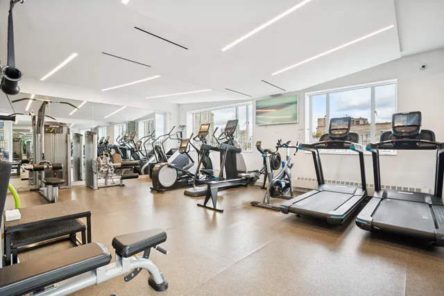 a roof deck with couches and potted plants with sky view