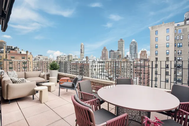a balcony with furniture and flowers