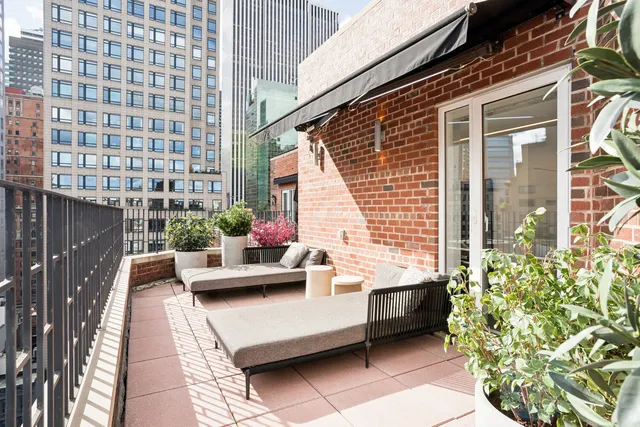 a living room with furniture a rug and a view of kitchen
