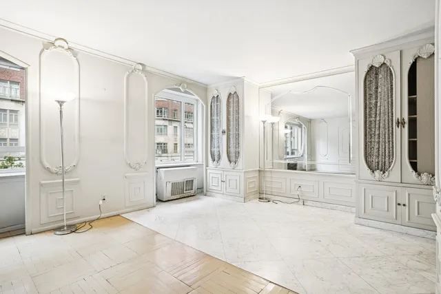 a spacious bathroom with a bathtub mirror and double vanity