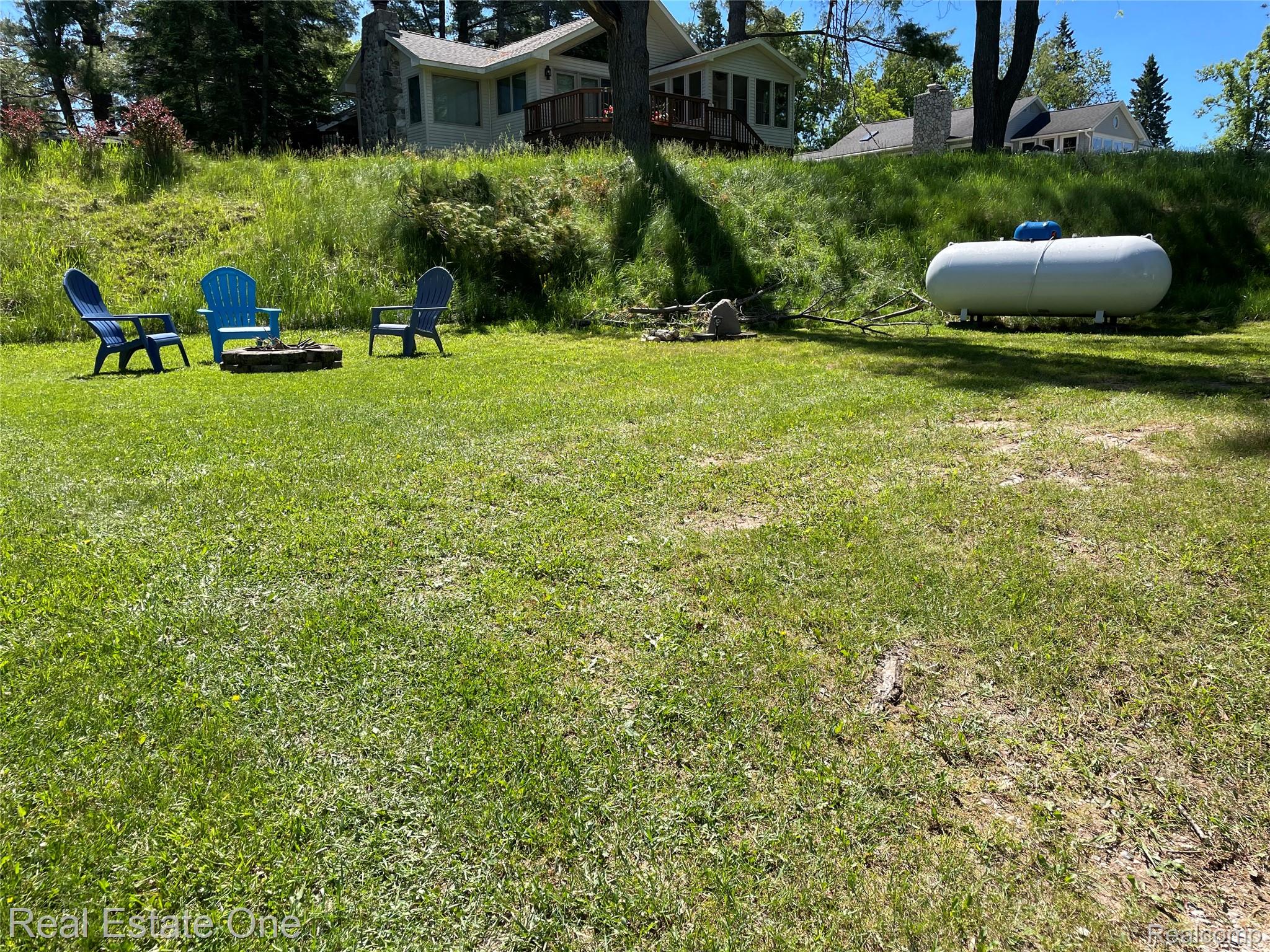 4160 Hawk Road Lincoln, MI 48742 - Photo 37 of 48 Expansive green lawn with a built-in fire pit