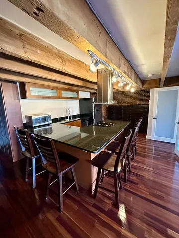 a dining room with furniture and wooden floor