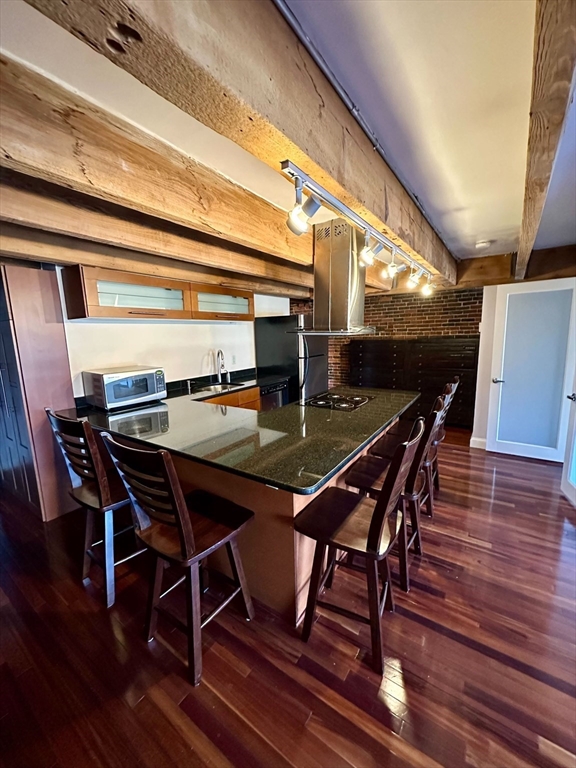 57 Fulton Street, Unit 11 Boston, MA 02109 - Photo 1 of 5 a dining room with furniture and wooden floor