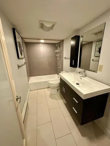 a bathroom with a sink toilet and mirror