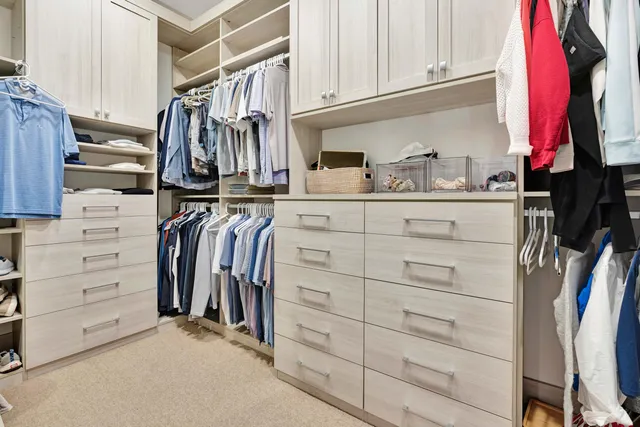 a bedroom with a bed and large windows