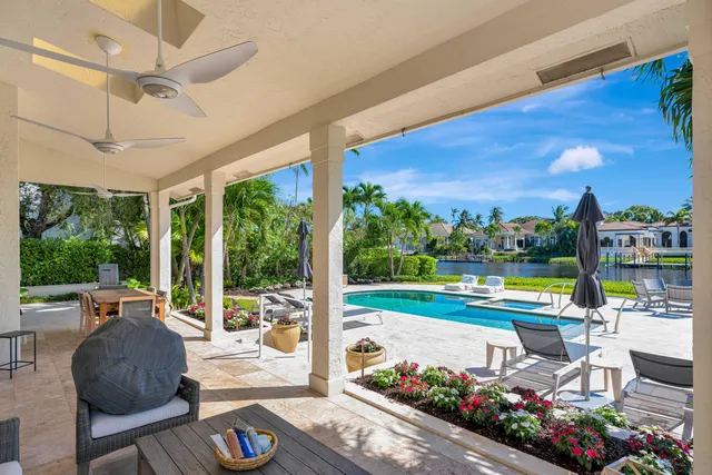 a view of a patio with swimming pool and outdoor seating