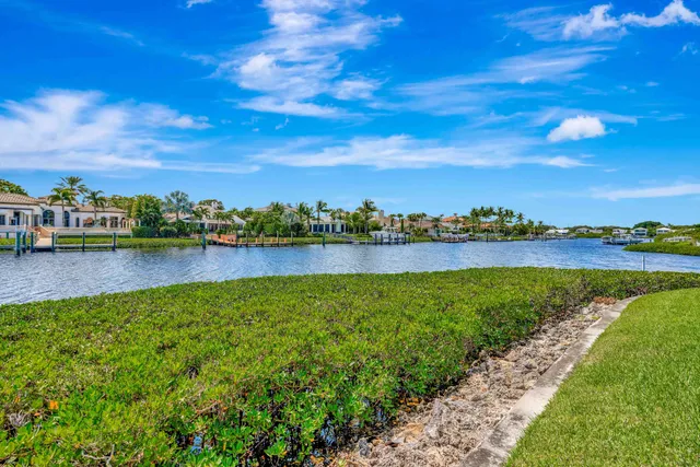 a view of a lake with houses in the back