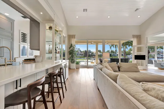 a kitchen with counter top space a sink wooden floor and stainless steel appliances