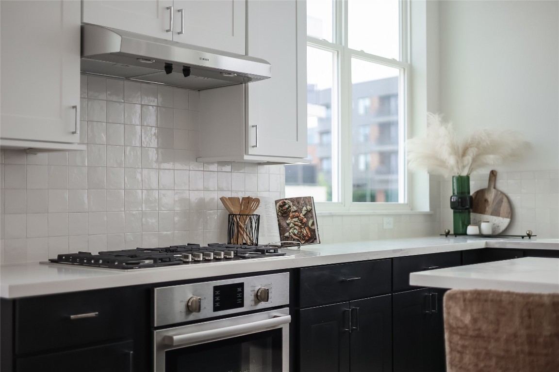 2805 McCurdy Street, Unit 19 Austin, TX 78723 - Photo 10 of 39 Sleek tile backsplash compliments the quartz countertops.
