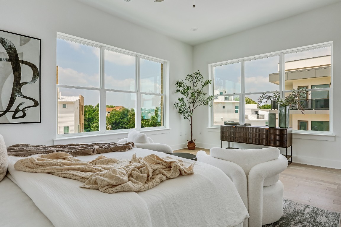 2805 McCurdy Street, Unit 19 Austin, TX 78723 - Photo 16 of 39 The primary suite is wrappe don oversized windows that infuse the room in peaceful natural light.