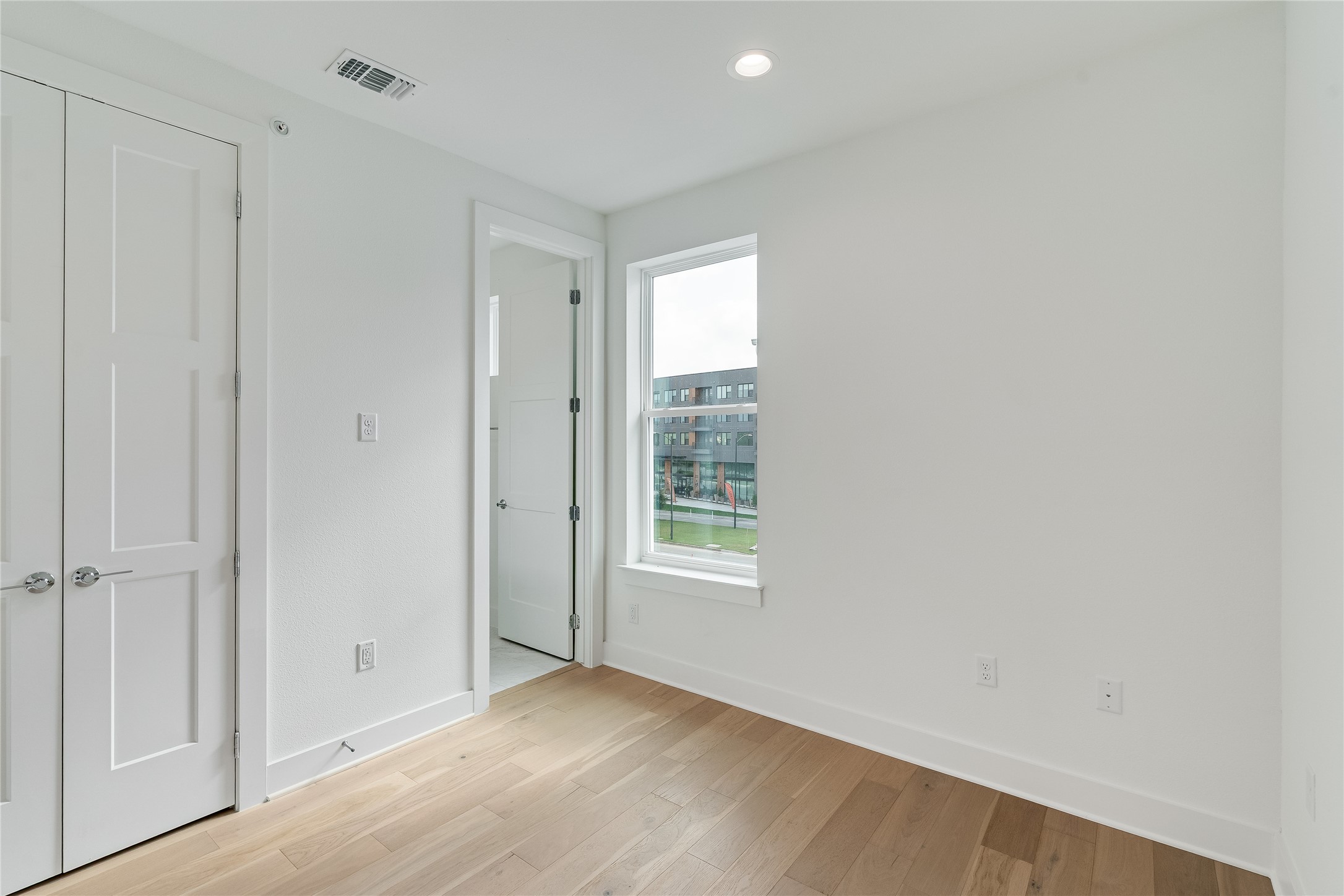 2805 McCurdy Street, Unit 19 Austin, TX 78723 - Photo 20 of 39 a view of an empty room with wooden floor and a window