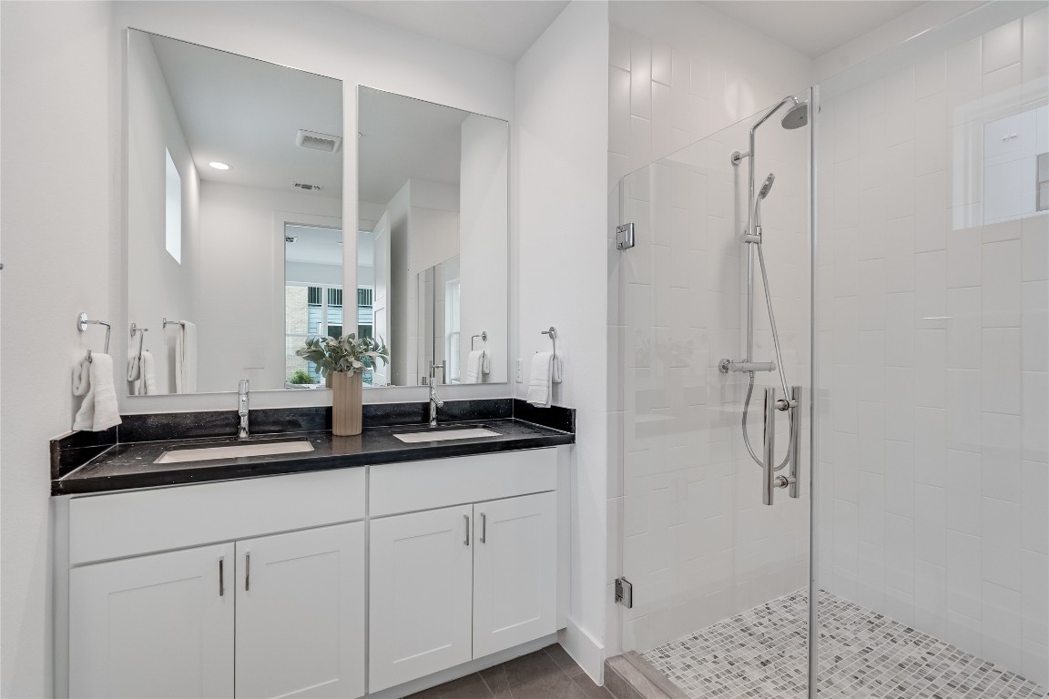 2805 McCurdy Street, Unit 19 Austin, TX 78723 - Photo 28 of 39 There is also a private ensuite bath with a dual vanity and walk-in shower.