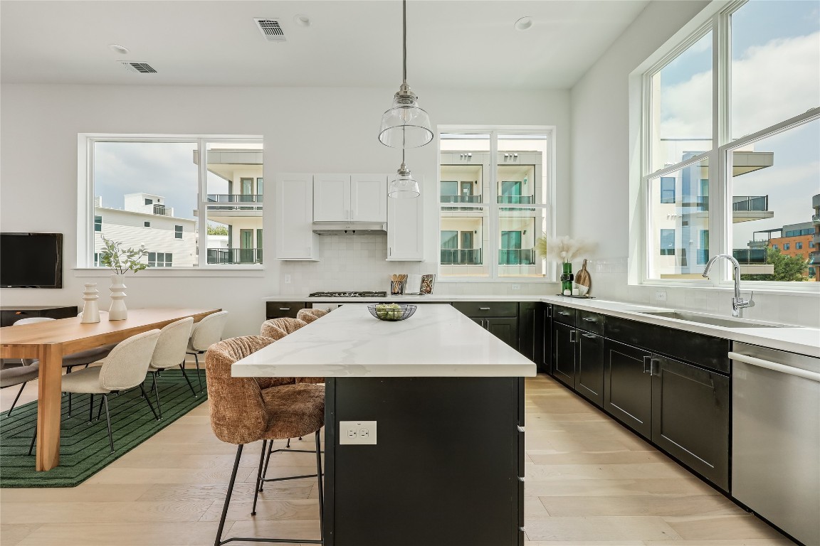 2805 McCurdy Street, Unit 19 Austin, TX 78723 - Photo 8 of 39 The large center island overlooks the main living area and offers inviting bar seating that everyone will want to gather around.